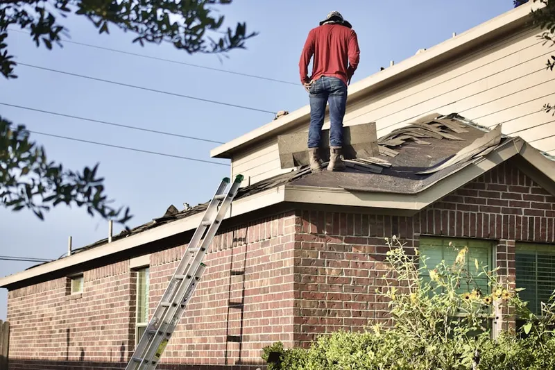 Professional roofer working on a residential roof in Rainier